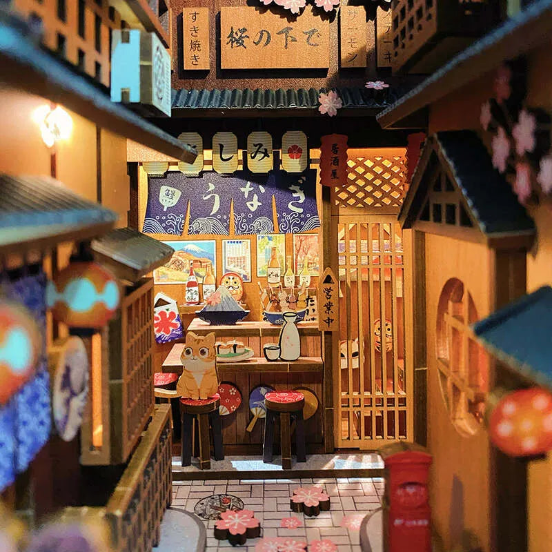 Book Nook - Under The Sakura Tree, un kit créatif pour construire un diorama miniature. Parfait pour décorer une bibliothèque ou comme cadeau original pour un amoureux des livres. Par Nookette.