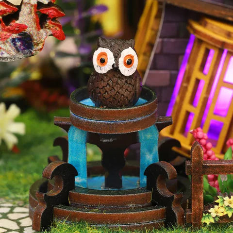 Hibou perché et fontaine miniature